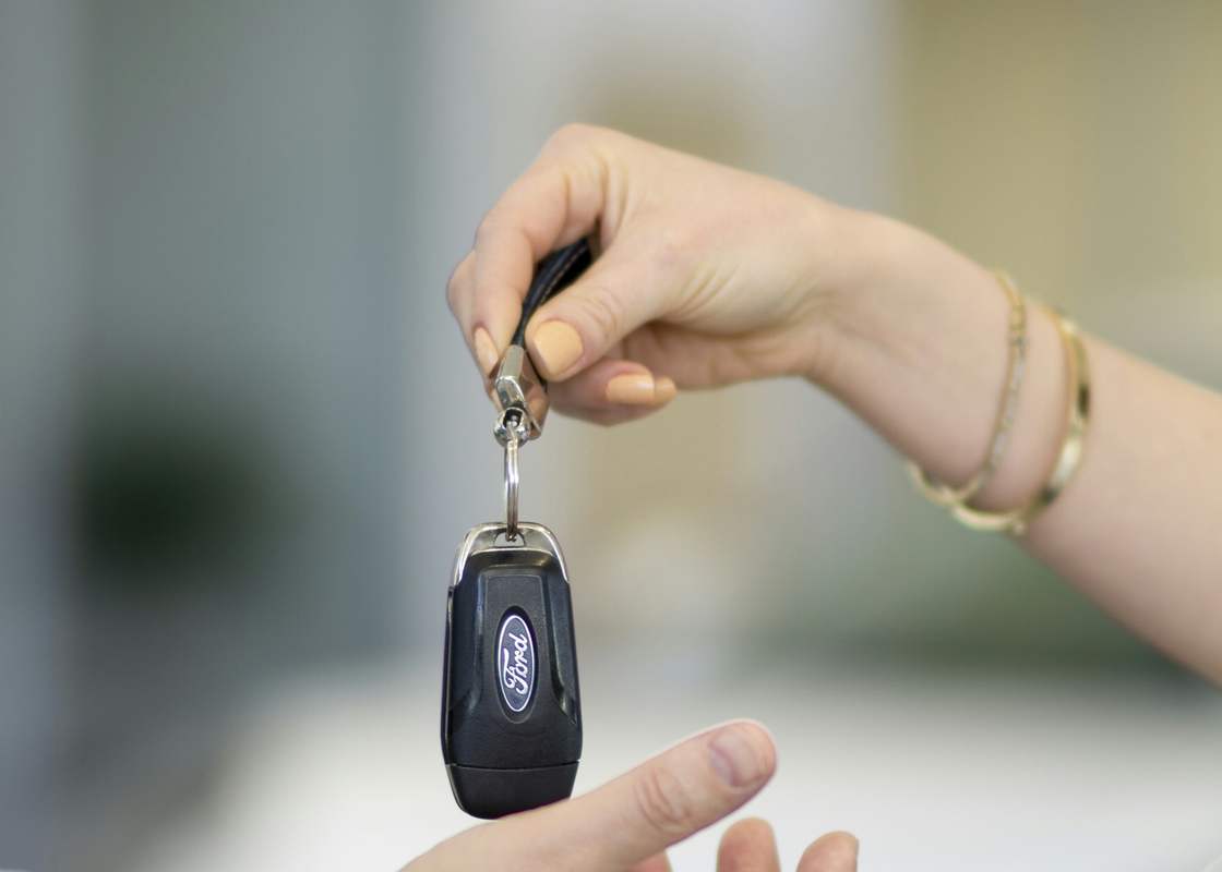 A set of car keys being handed over